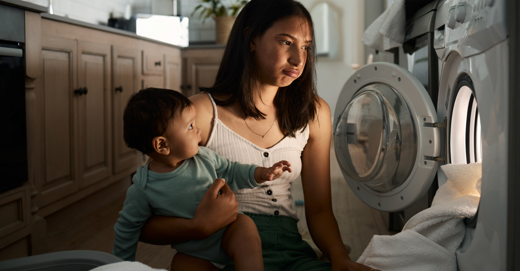 Mental Load - Mum caring for baby and doing laundry