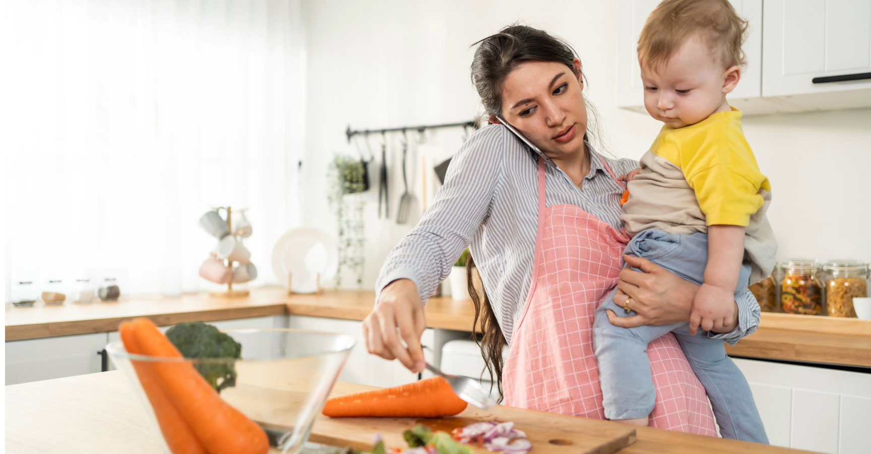 Mental Load - Mum holding toddler while prepping a meal