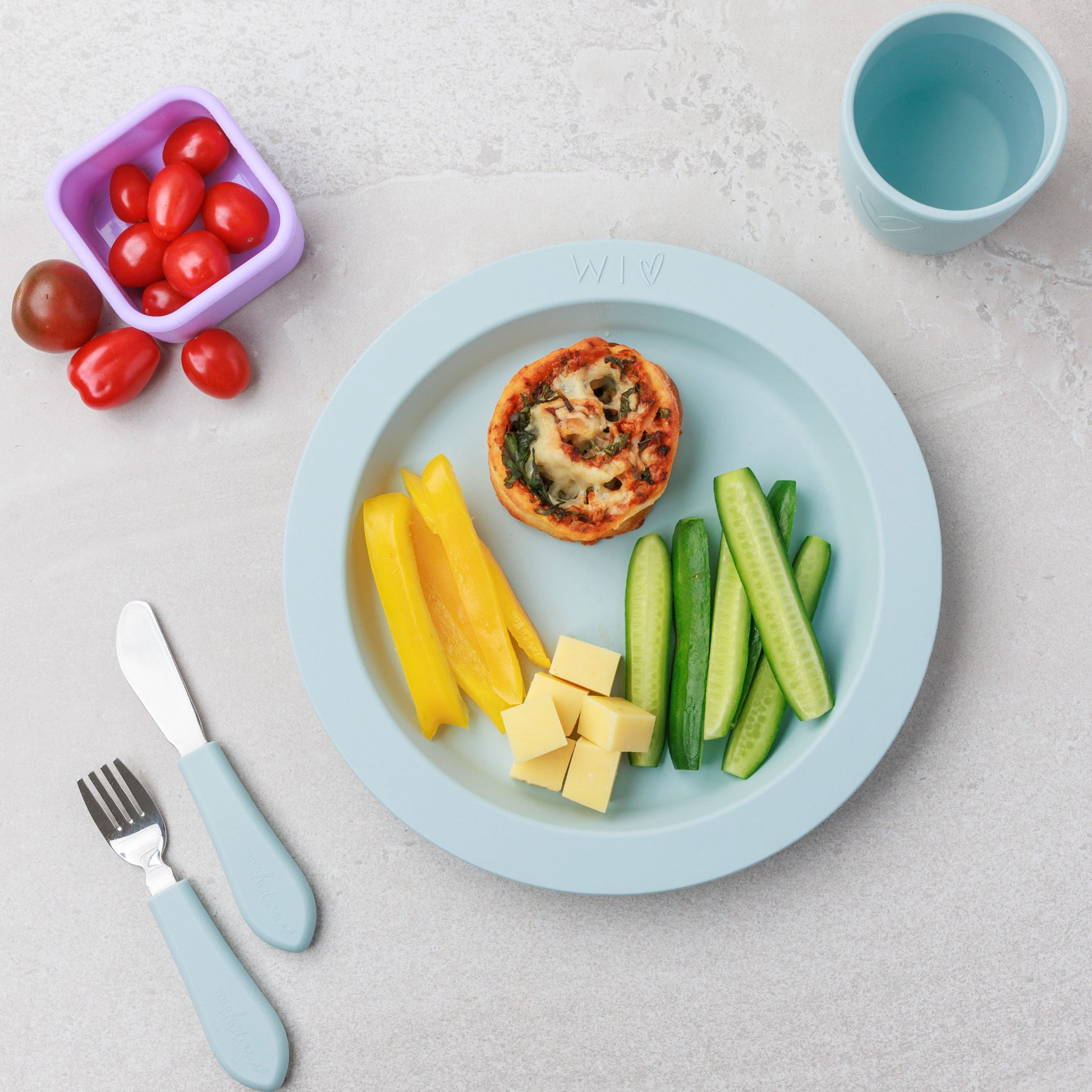 A plate of Veggie Pizza Scrolls served with veggies and cheese from Audrey and Alfie's Finger Food Range