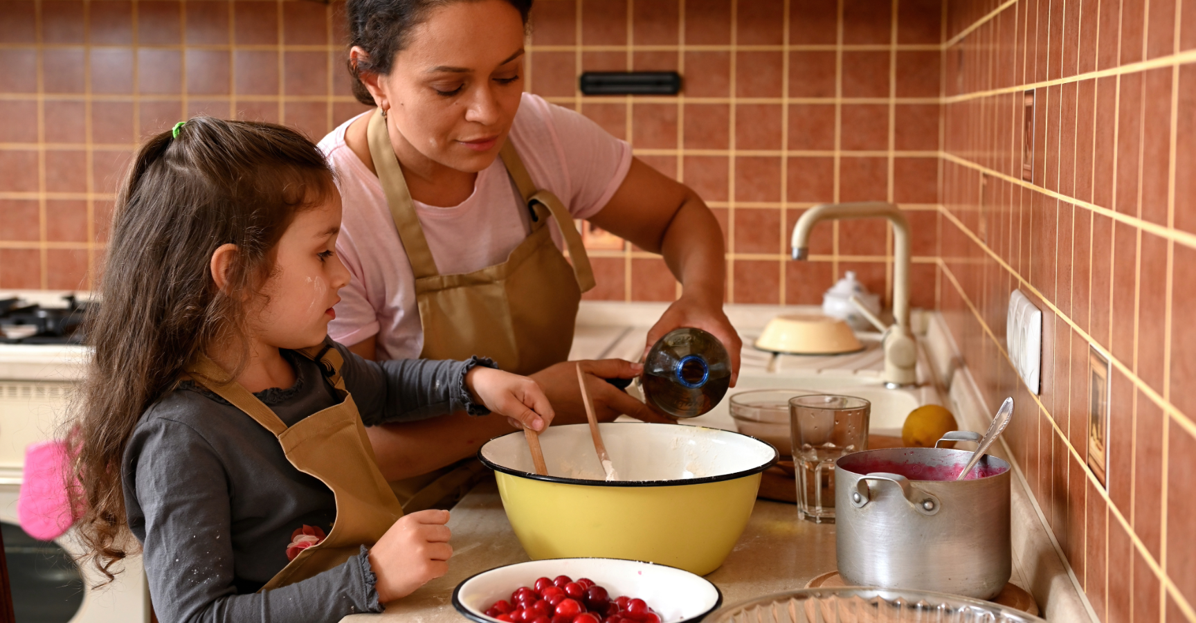 Encouraging kids to eat veggies - Kid cooking with mum in kitchen