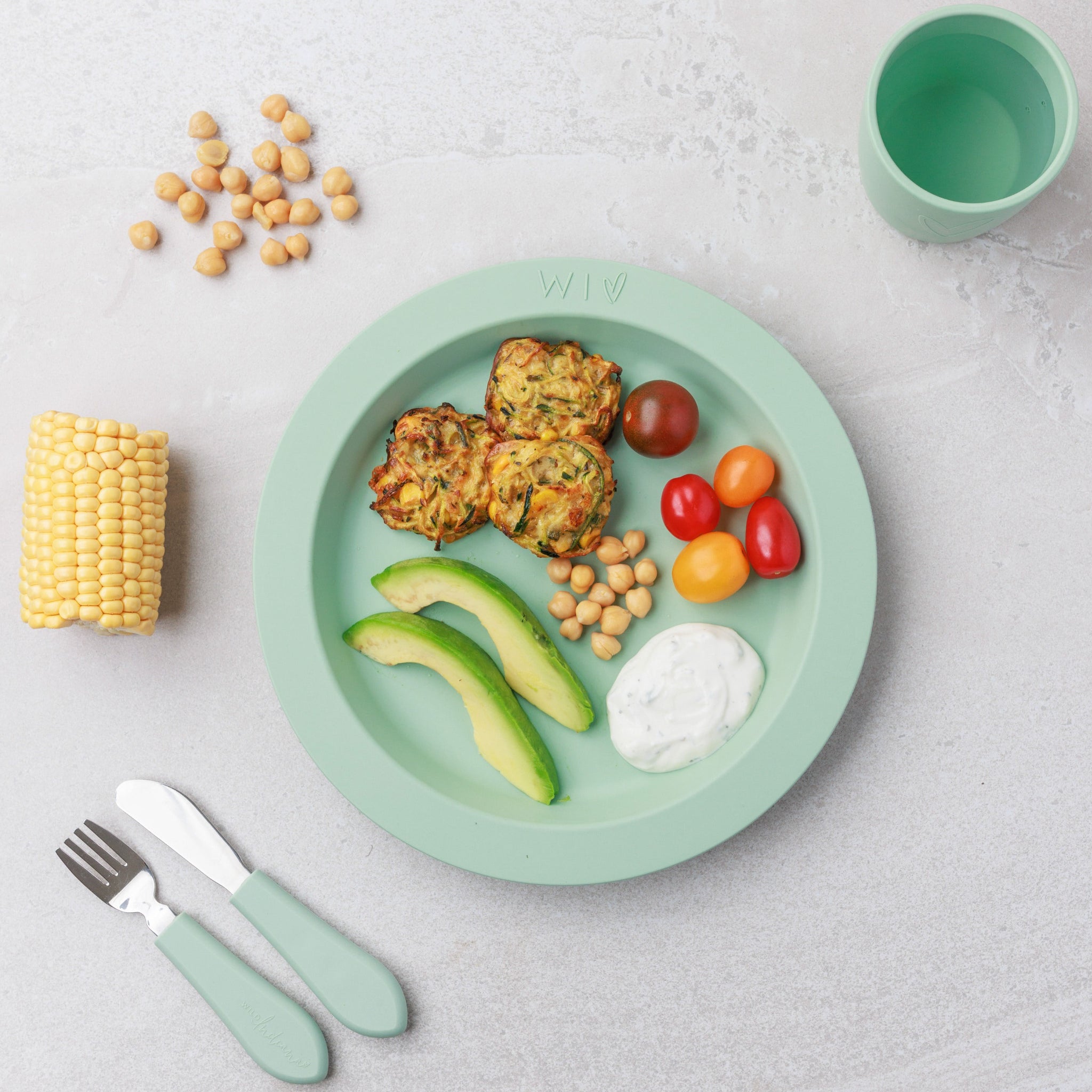 A plate of Zucchini & Corn Fritters served with veggies from Audrey and Alfie's Finger Food Range