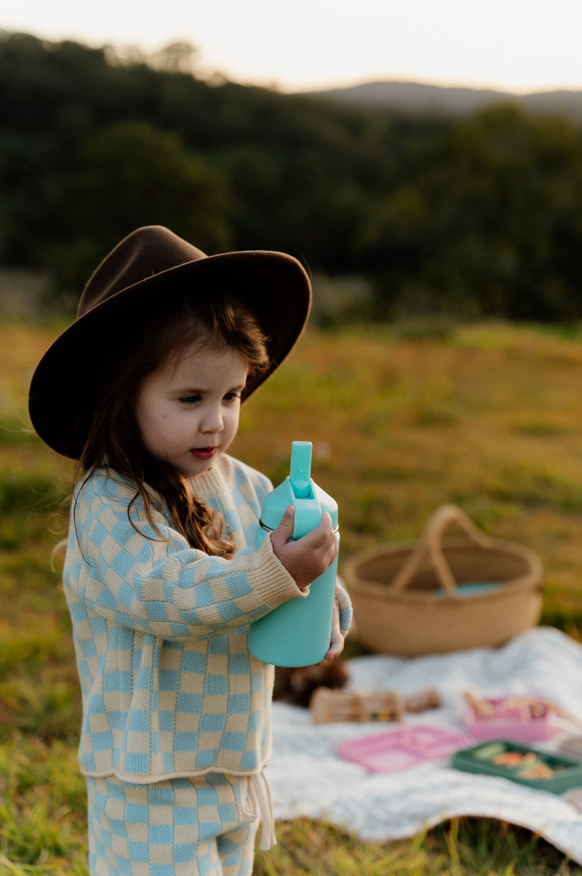 Toddler drinking from a water bottle from The Zero Waste People